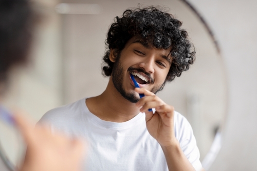 man brushing his teeth