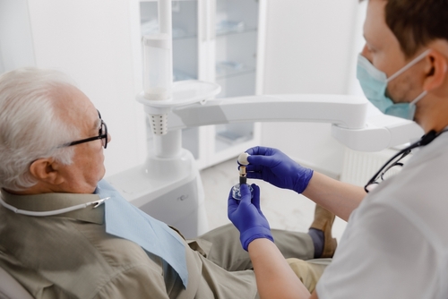 dentist showing patient how dental implants work