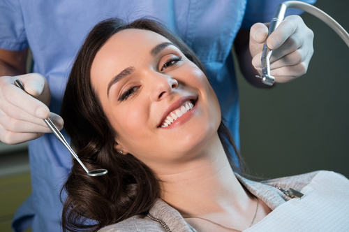 young woman smiling at the dentist